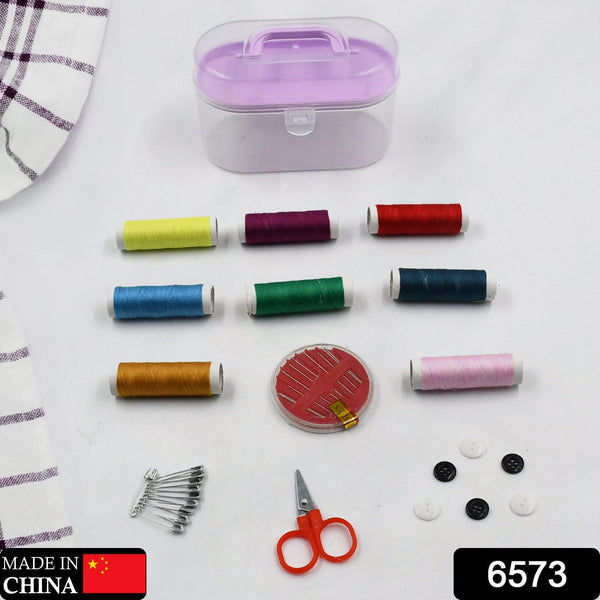 Small sewing kit box with scissors and pins, designed for travel and handwork.