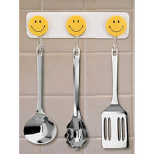 Pack of 3 self-adhesive smiley hooks for home use.