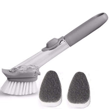 Side view of dishwashing brush in use, highlighting the handle and bristles.