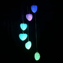 Garden wind chimes with solar power and LED lights for nighttime ambiance.