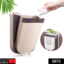 Small foldable trash bin for bathroom or office use.